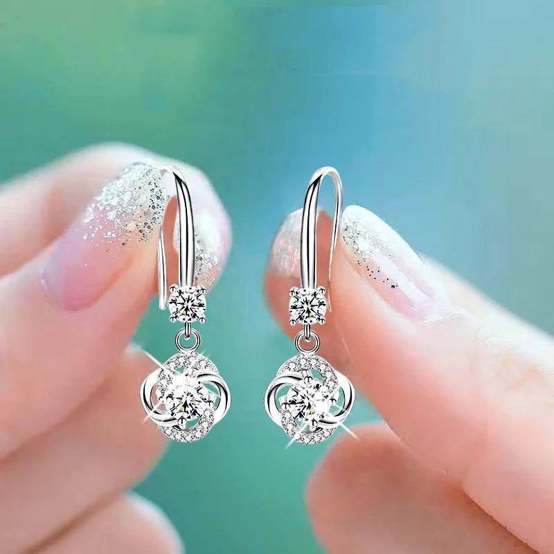 Silver four-leaf clover stud earrings with fairy hooks, symbolising happiness