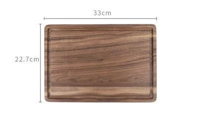 Black walnut wood cutting board with engraved handle and groove design for kitchen use