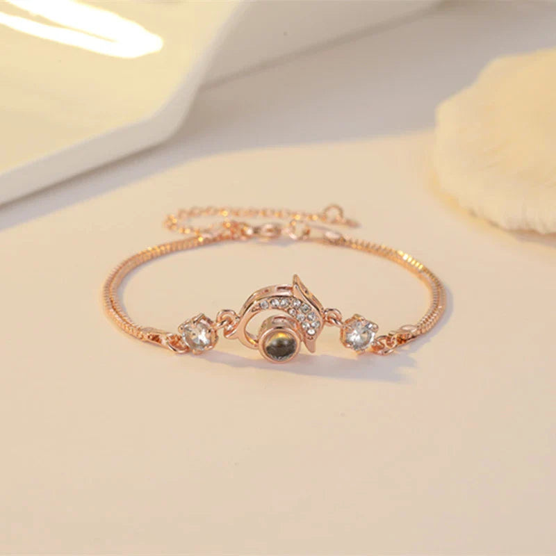 A pair of vibrant projection couple bracelets in rose gold and platinum colors