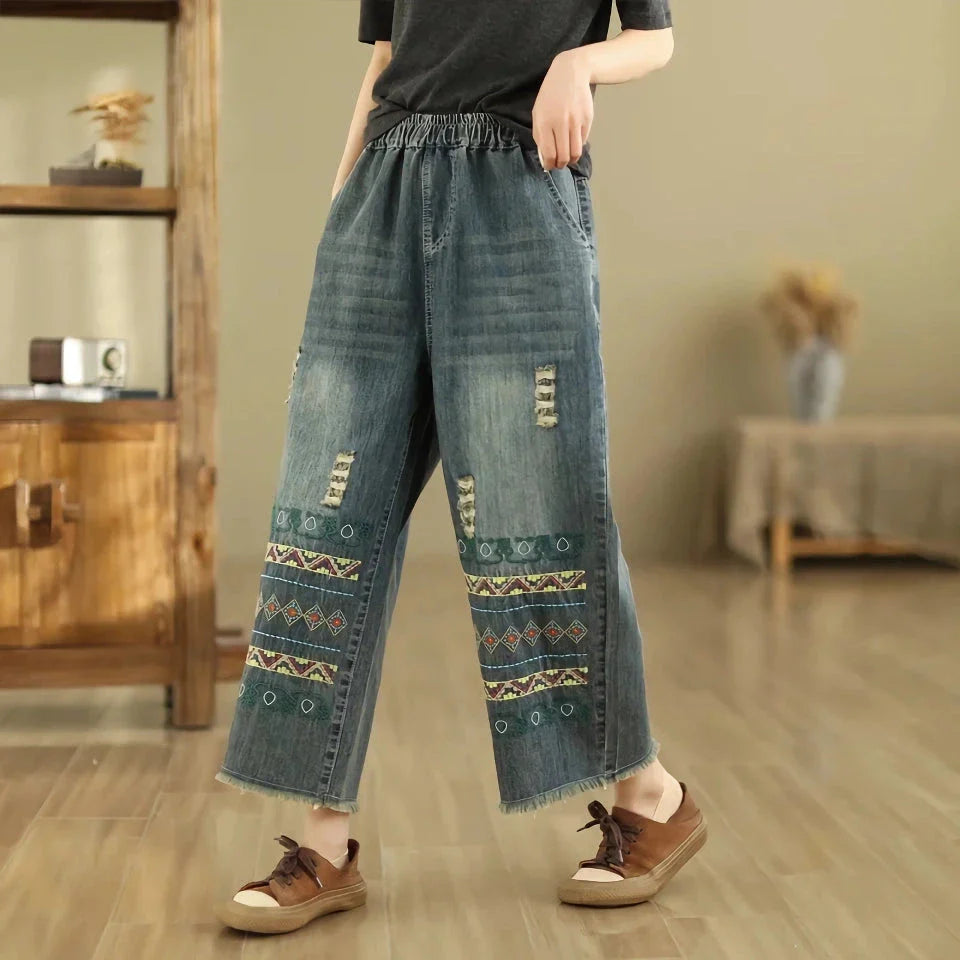 Vintage-inspired embroidered wide-leg jeans in a relaxed, bohemian style with a high-waist design and elastic closure for a personalized fit