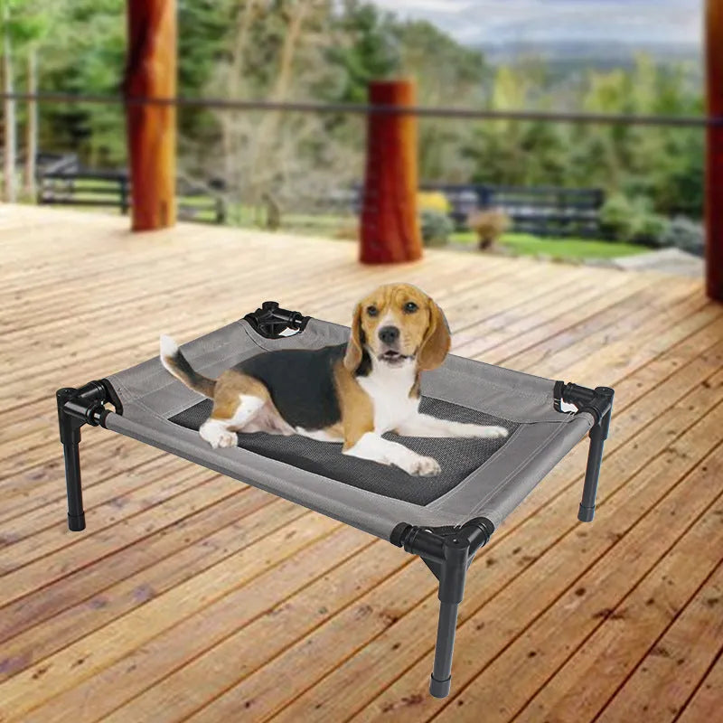 Black portable outdoor dog bed with steel frame and removable Oxford cloth cover, shown on grass.
