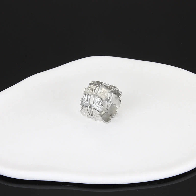 Adjustable stainless steel finger ring with unique charm designs in steel and gold colours