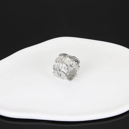 Adjustable stainless steel finger ring with unique charm designs in steel and gold colours