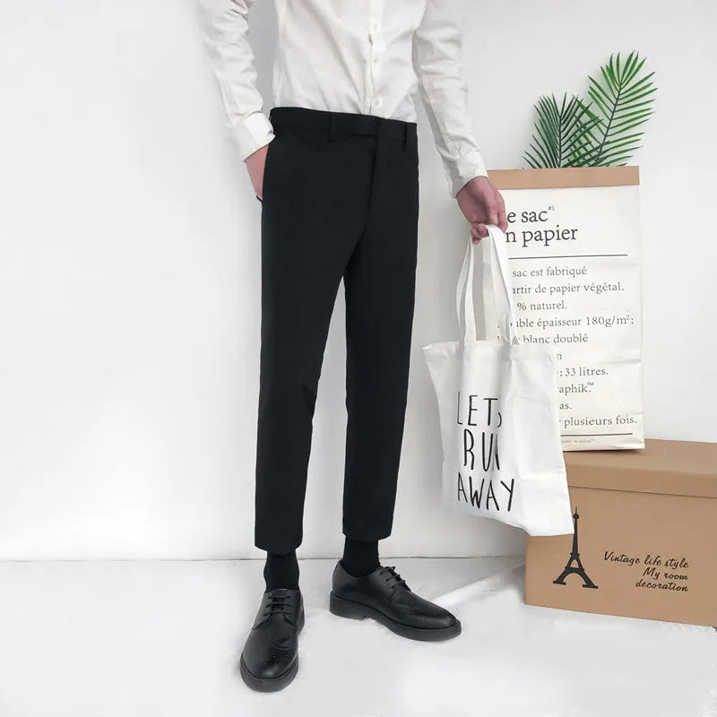 Men's slim straight-leg cotton trousers with a drawstring waist in black, shown front and side.