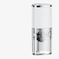 Black and white portable electric coffee grinder with USB charging cable on a kitchen counter.