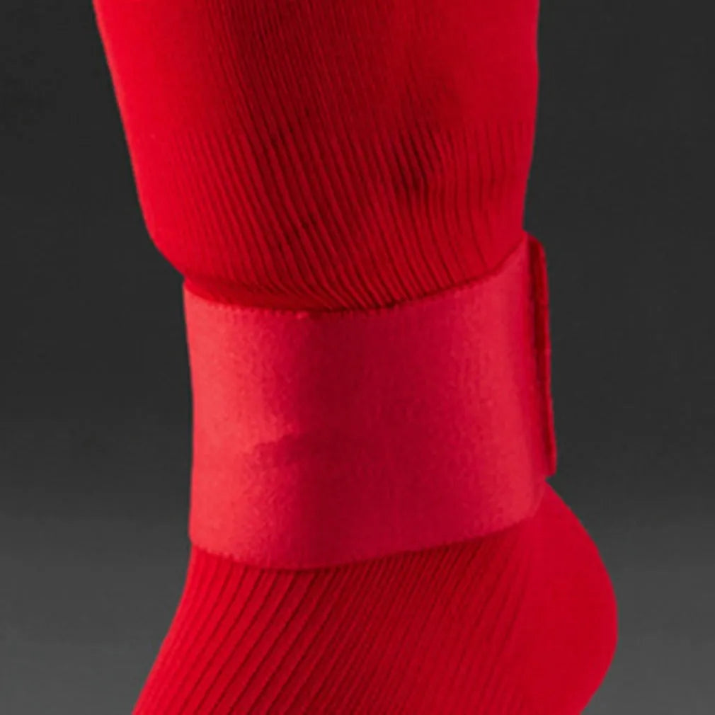 Red rubber elastic strap for securing football shin guards, shown flat to display its 250mm length.