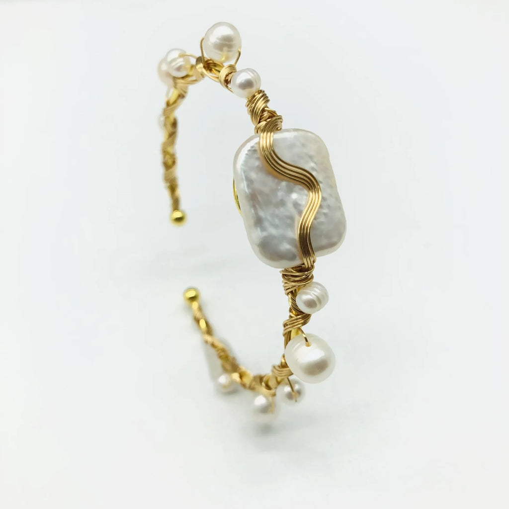 Natural freshwater pearl bracelet with gold titanium steel wire-wrap on hand model