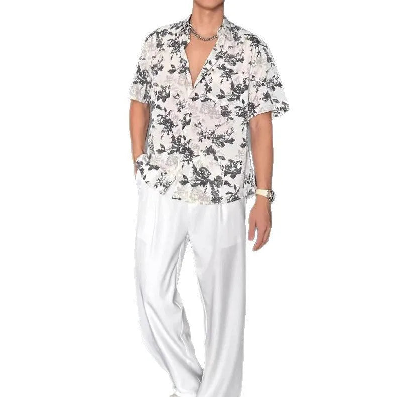 Men's loose-fit black short sleeve shirt with a white floral print pattern.