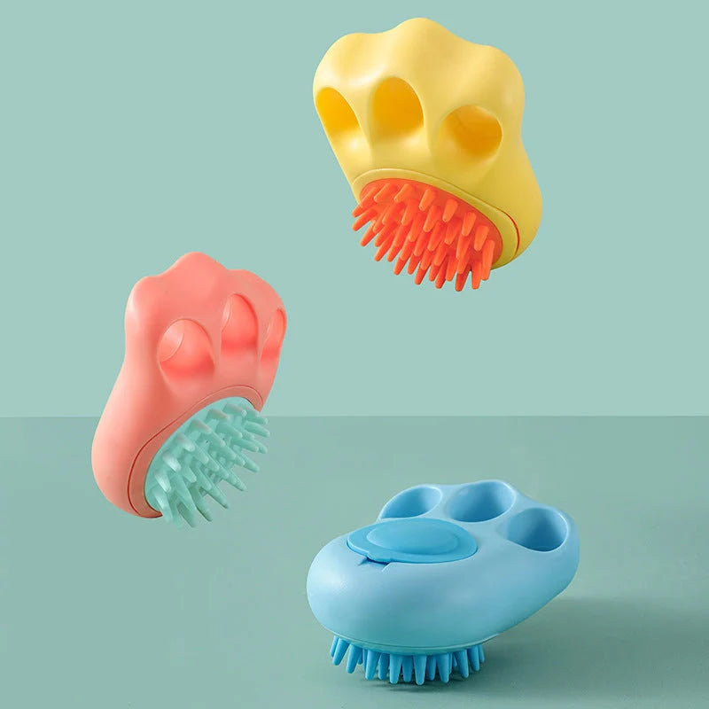 Claw-shaped pet grooming brush in pink, blue, yellow, and grey for cats and dogs
