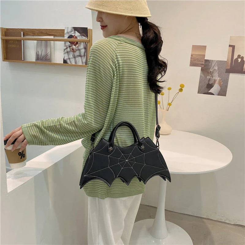 A stylish PU leather shoulder bag with a unique spider web and Batgirl-inspired design, available in a variety of vibrant colors.