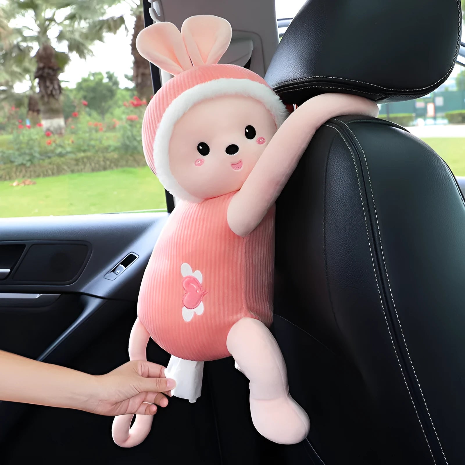 Plush fabric car seat back tissue box holder with animal character design mounted behind car headrest