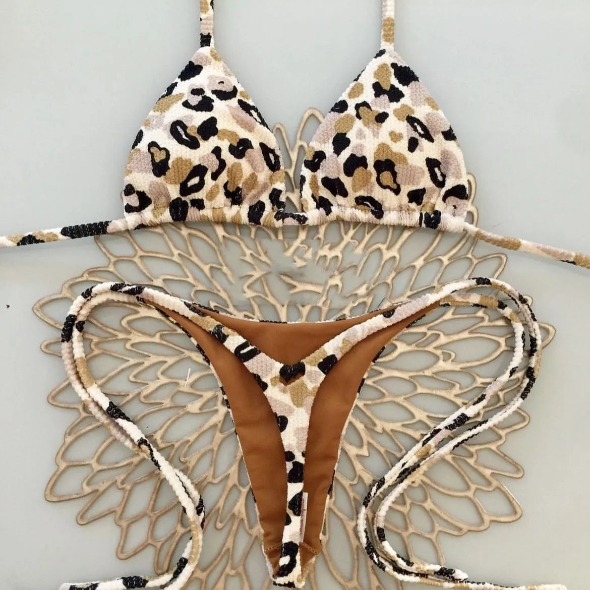 Women's printed bikini swimsuit with briefs style on a mannequin, showing the cotton lining and high elasticity fabric.