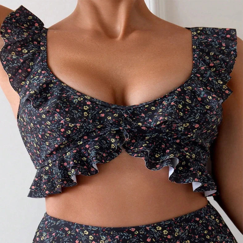 Women's backless floral print split swimsuit with pink, green, blue, purple flowers on black background