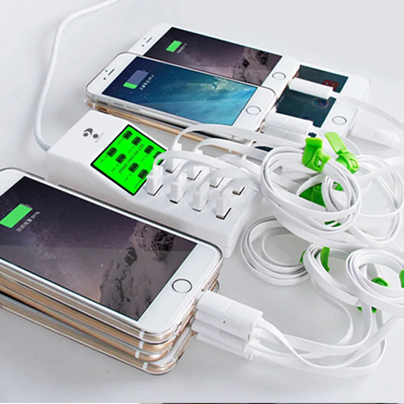White multi-port USB mobile phone charger with UK, EU, US plug adapters on a desk