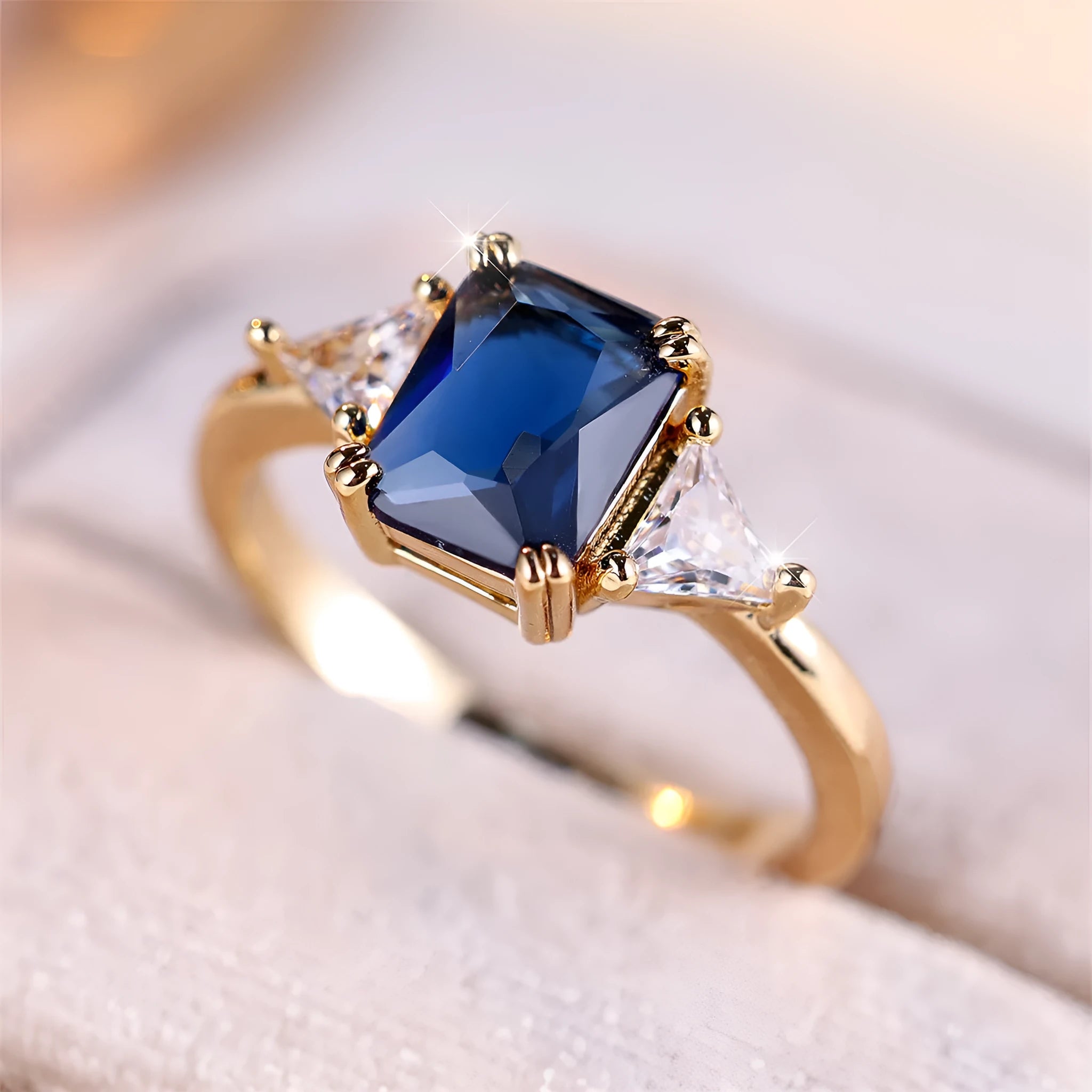 Rectangular copper ring with gold sapphire blue finish, shown on hand