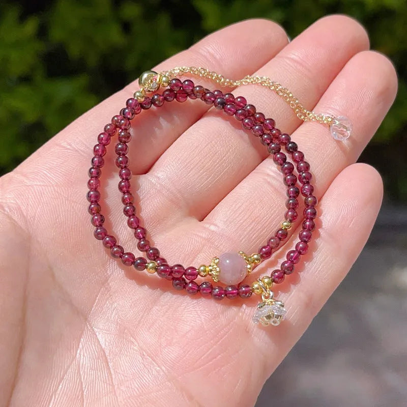 Women's double ring bracelet with natural red garnet beads and adjustable clasp.