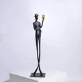 Black cast aluminium desktop sculpture of a woman reading, modern simplicity style, 51cm tall.