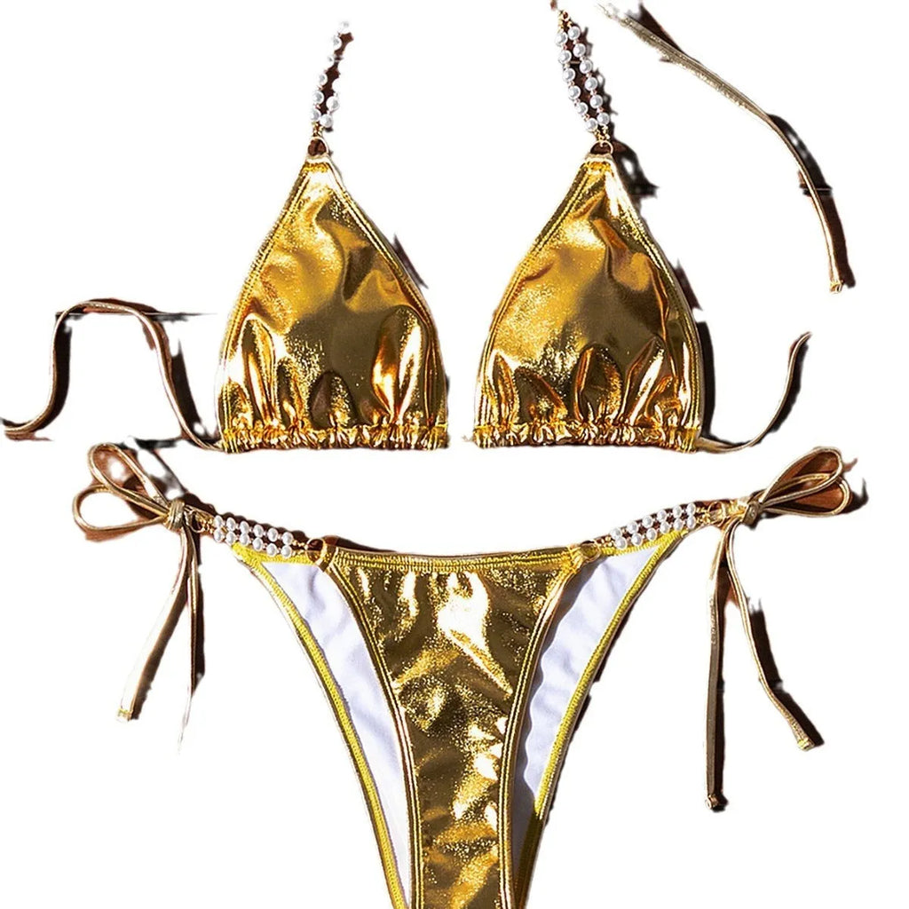 Gold women's bikini swimsuit with halter neck, lace-up back, and pearl chain decoration