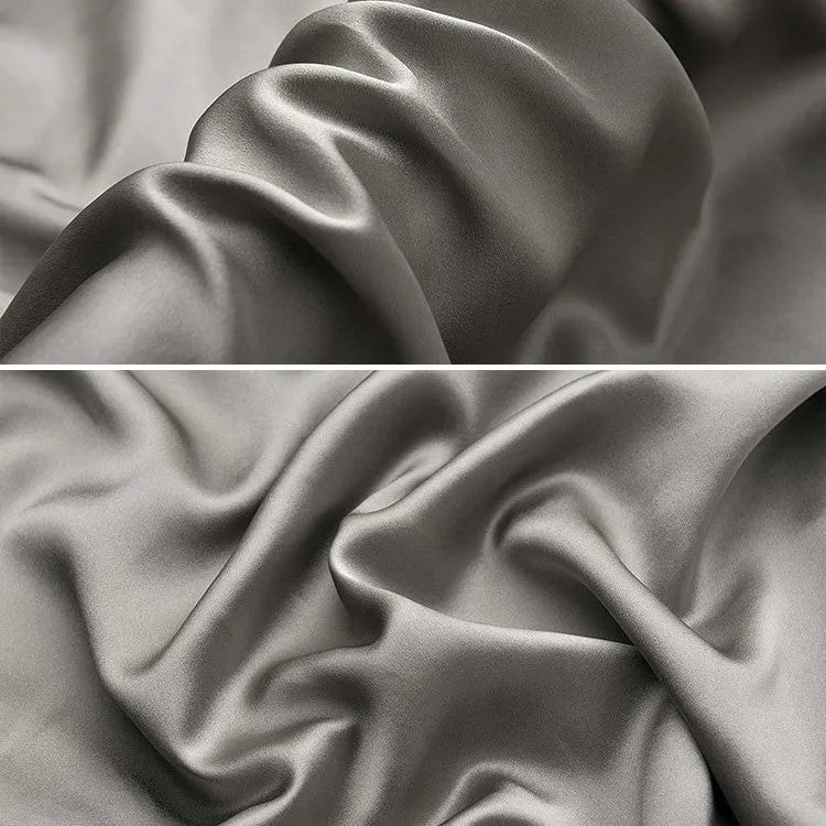 Dark grey mulberry silk pillowcase with envelope closure, shown in a modern bedroom setting.