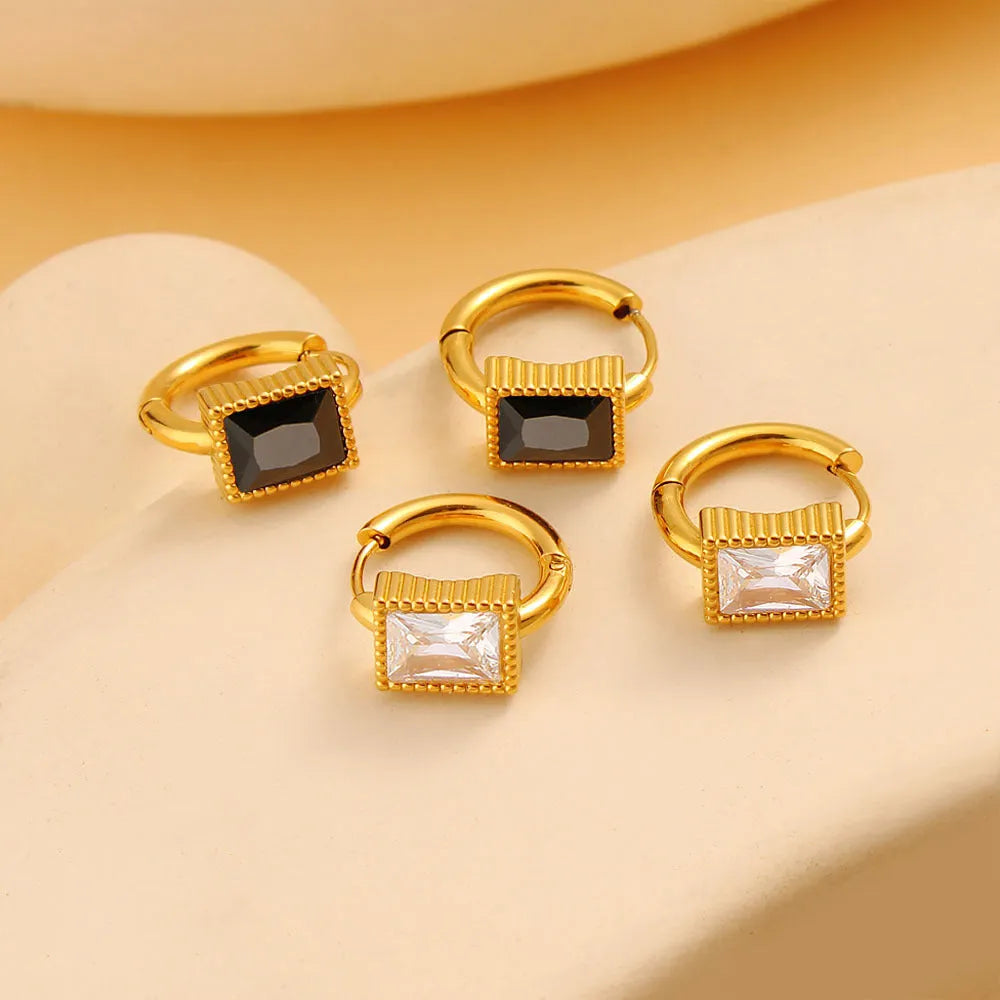 Square geometric stainless steel earrings with round rings and zircon accents, shown in white, black, and green colour options.