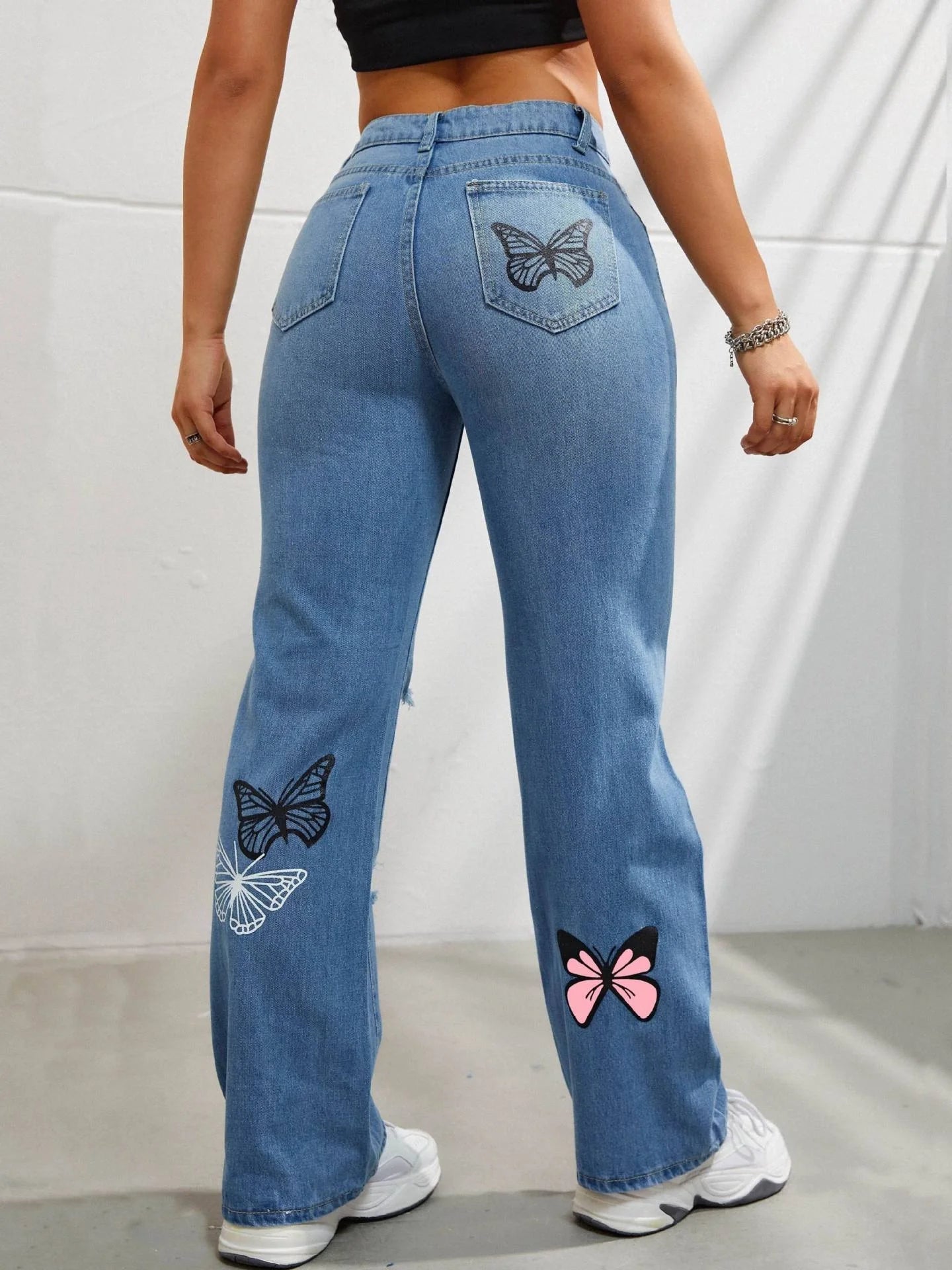 Women's high-waisted straight-leg jeans with butterfly print and distressed details