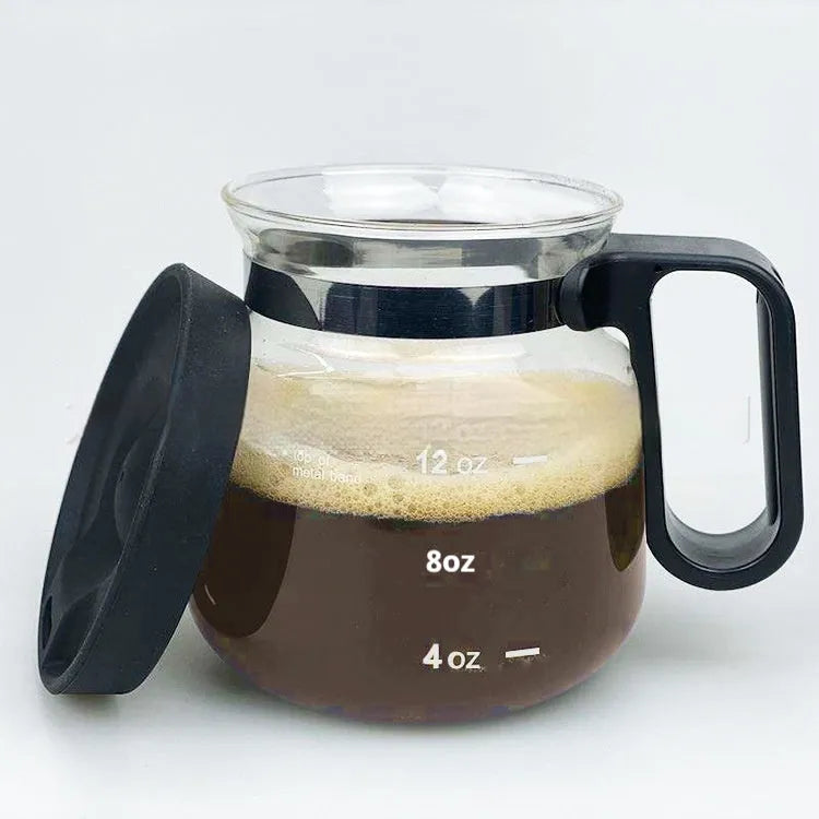 Transparent borosilicate glass coffee maker with a black silicone cover for pour-over brewing.