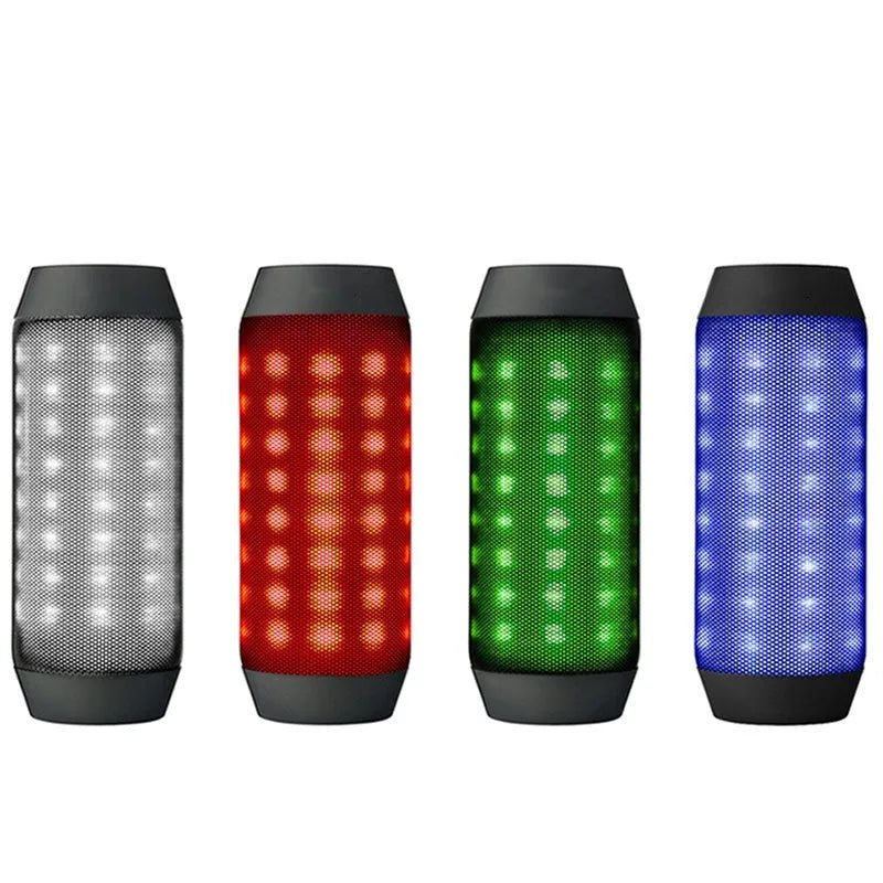 Black Bluetooth speaker with metal shell, colourful LED lights, and button controls on a desk