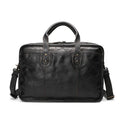 Vintage brown leather men's briefcase showing internal laptop and camera compartments.