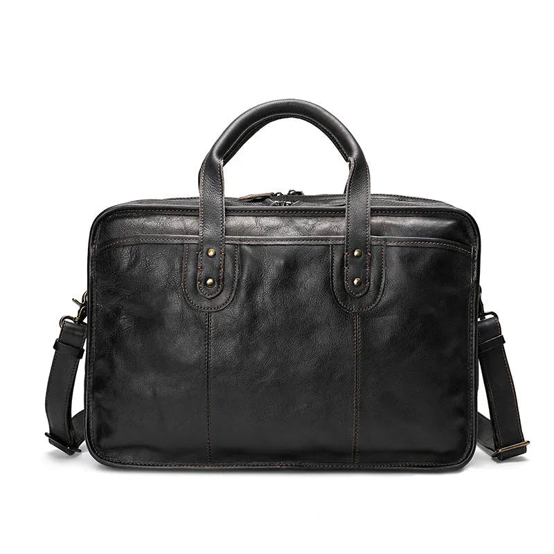 Vintage brown leather men's briefcase showing internal laptop and camera compartments.