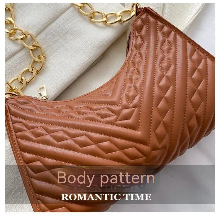 Brown pleated chain strap baguette shoulder bag showing vertical square shape and soft handle.