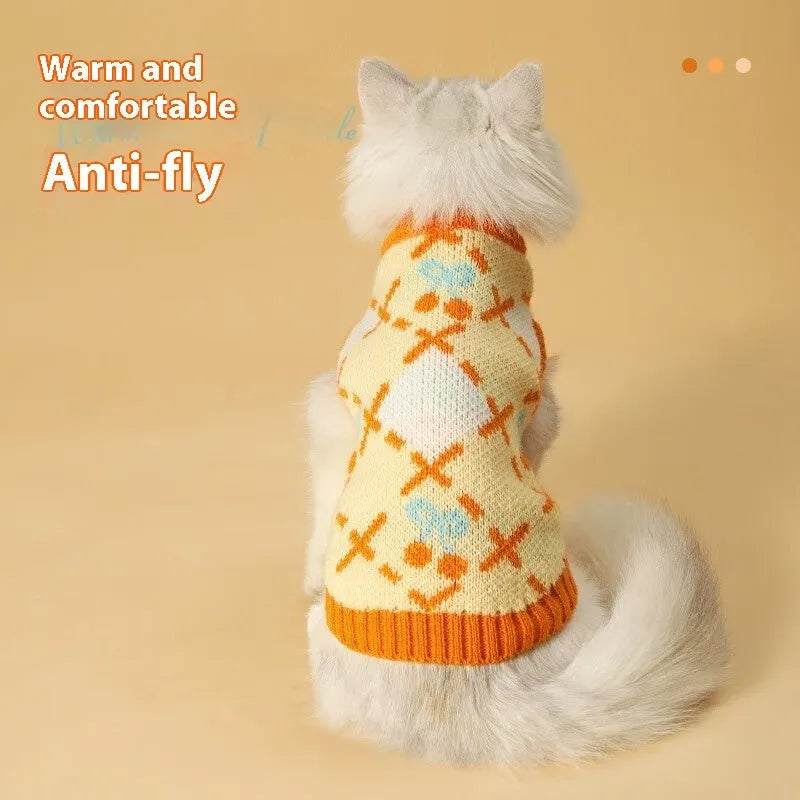 Orange cherry coloured thick knit cat sweater for autumn and winter, shown on a cat.