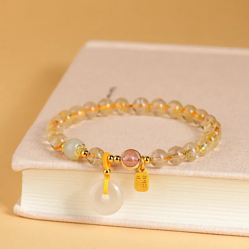 Gold rutilated quartz crystal bracelet with peace buckle closure and blessing card pendant