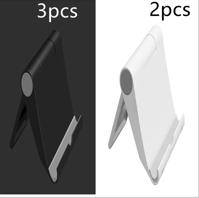 Black PE plastic folding stand holding a tablet at an adjustable angle on a wooden desk.