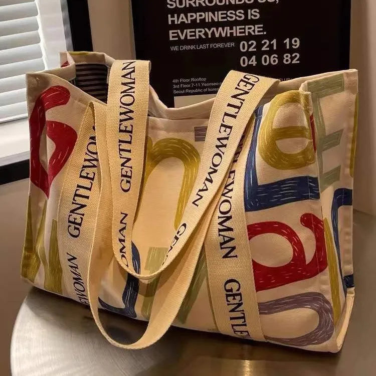 Large canvas women's tote shopping bag with printed design in choice of black letters, coloured letters, or pattern style.