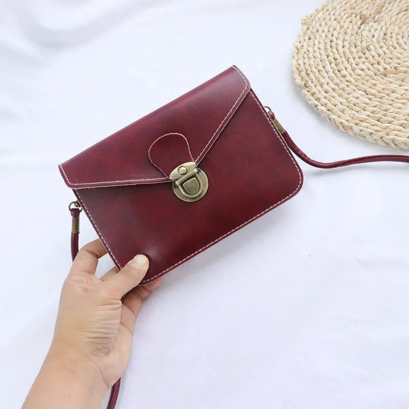 Retro soft surface messenger bag with crossbody strap and secure lock closure