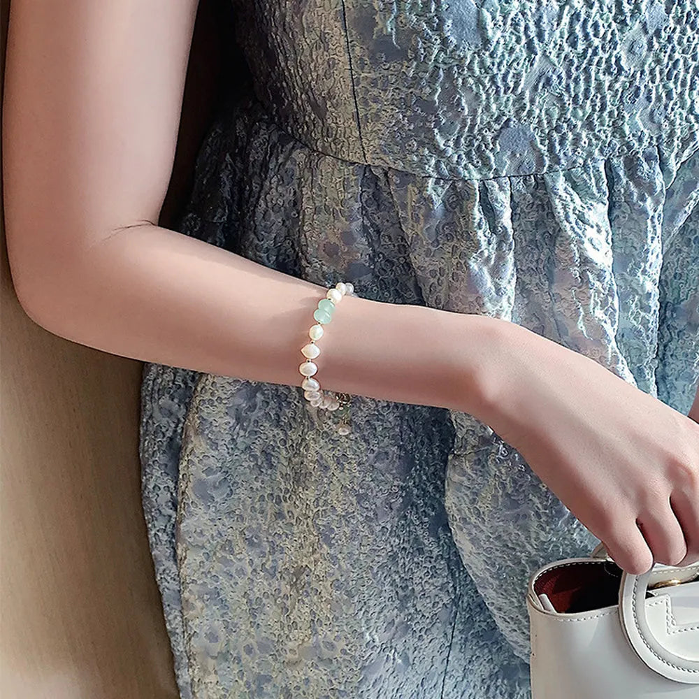 Women's irregular freshwater pearl adjustable bracelet on a plain background showing the alloy clasp and irregular pearl beads