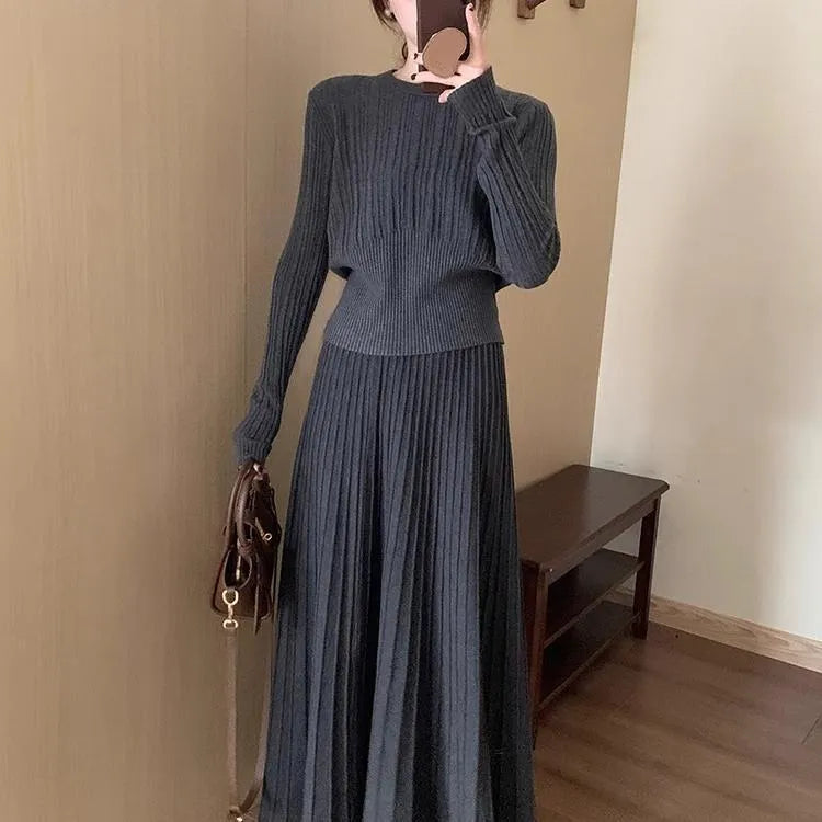 Dark grey knitted dress suit set with 3D pattern, featuring a sweater and skirt.