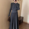 Dark grey knitted dress suit set with 3D pattern, featuring a sweater and skirt.