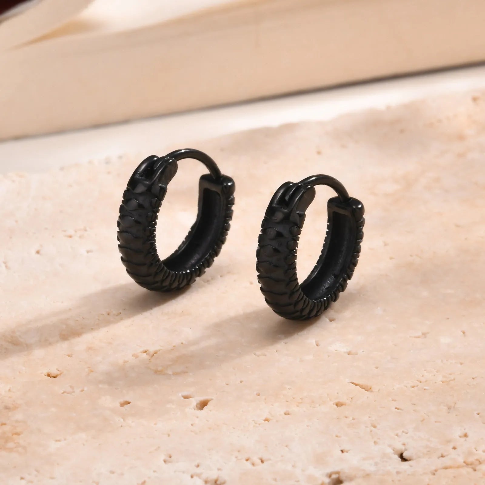 Stainless steel snake pattern earrings in black and gold colour options