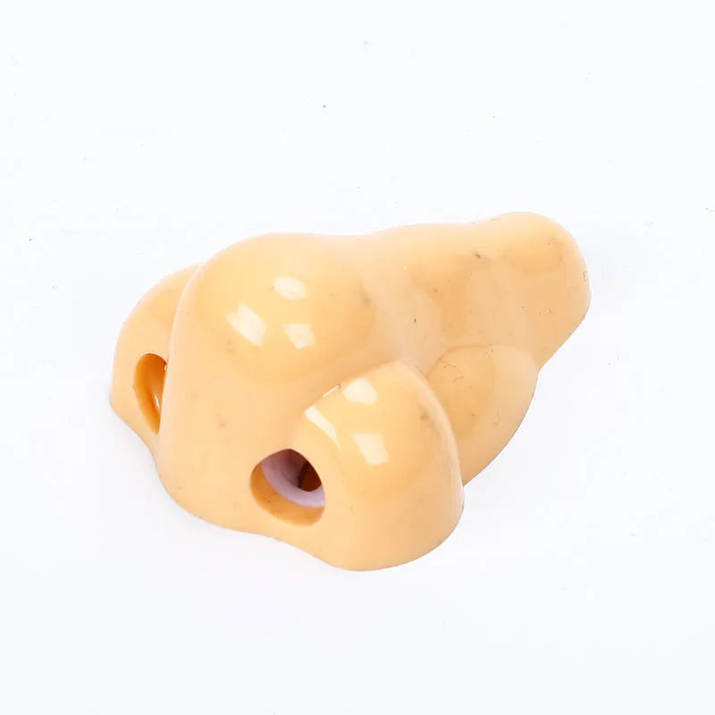 Flesh-coloured geometry-shaped plastic pencil sharpener with big nostril for standard pencils.