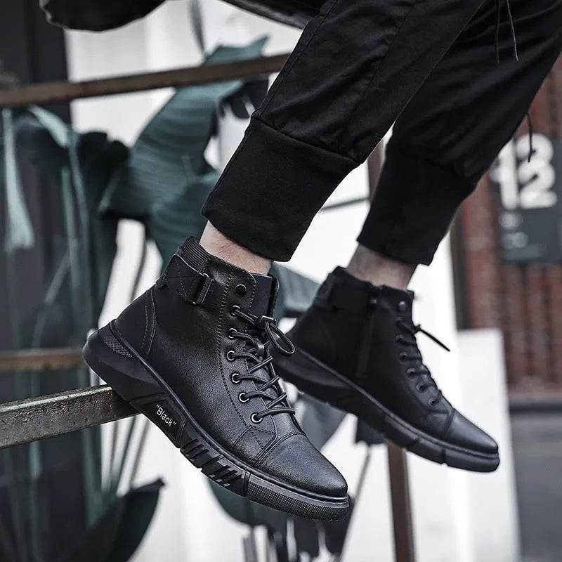 Black high-top men's leather boots with cotton lining and rubber sole on wooden floor
