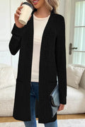 Black loose fit knitted cardigan jacket with long sleeves and side pockets on a mannequin.