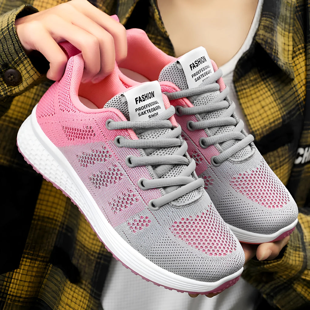 Women's black flyknit casual running shoes with white soft sole and flat heel on a grey background.