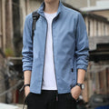 Man wearing a loose-fit black lapel collar casual jacket, Korean style, with zippered pockets.