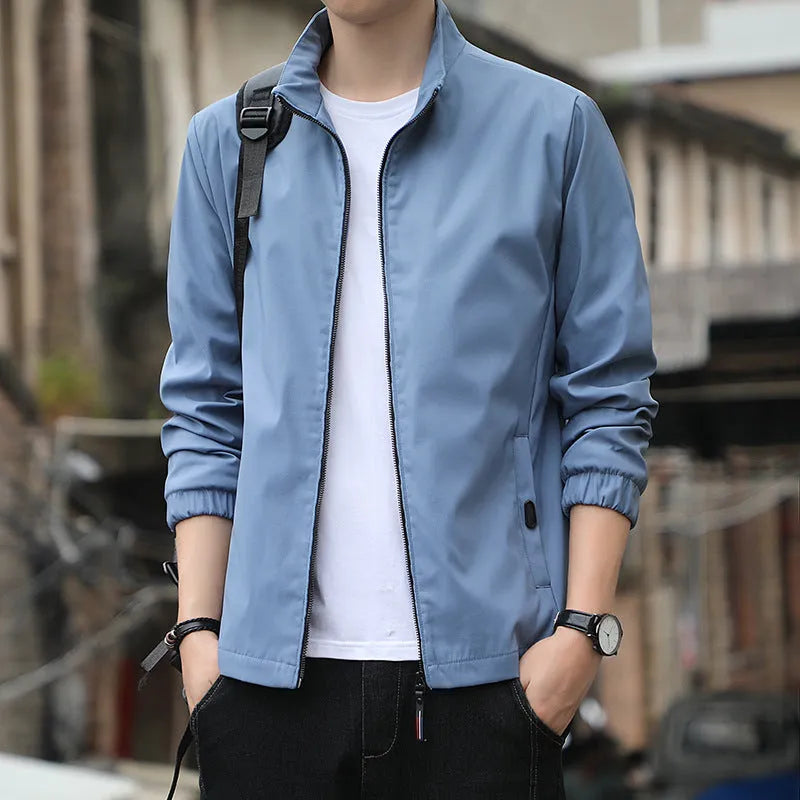 Man wearing a loose-fit black lapel collar casual jacket, Korean style, with zippered pockets.