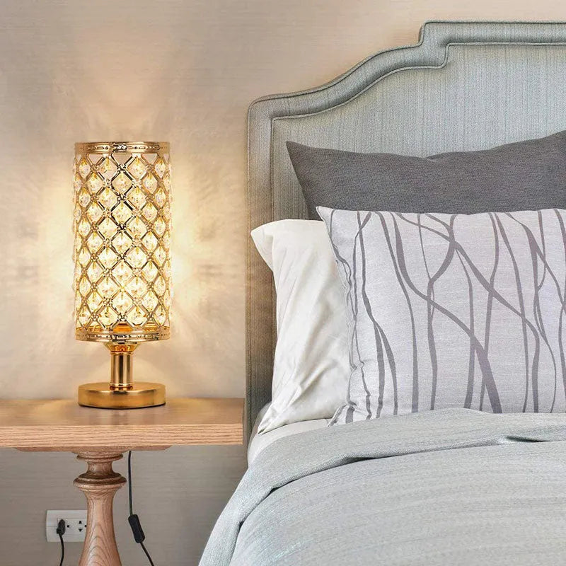 Modern crystal table lamp with metal base and hollow-carved shade in gold finish