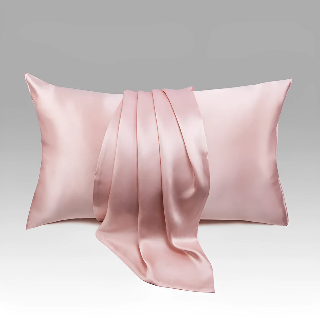Dark grey mulberry silk pillowcase with envelope closure, shown in a modern bedroom setting.