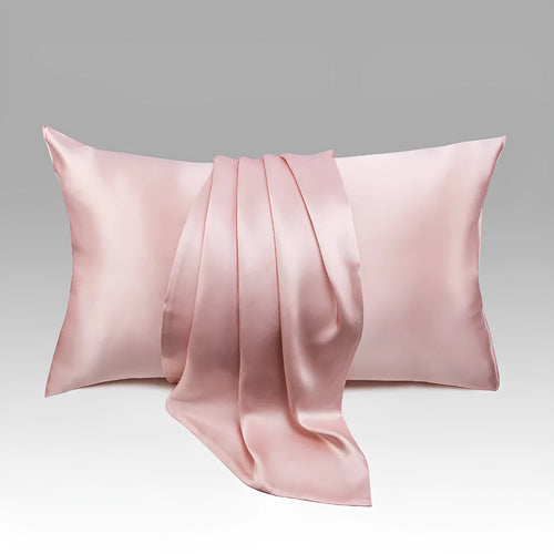 Dark grey mulberry silk pillowcase with envelope closure, shown in a modern bedroom setting.