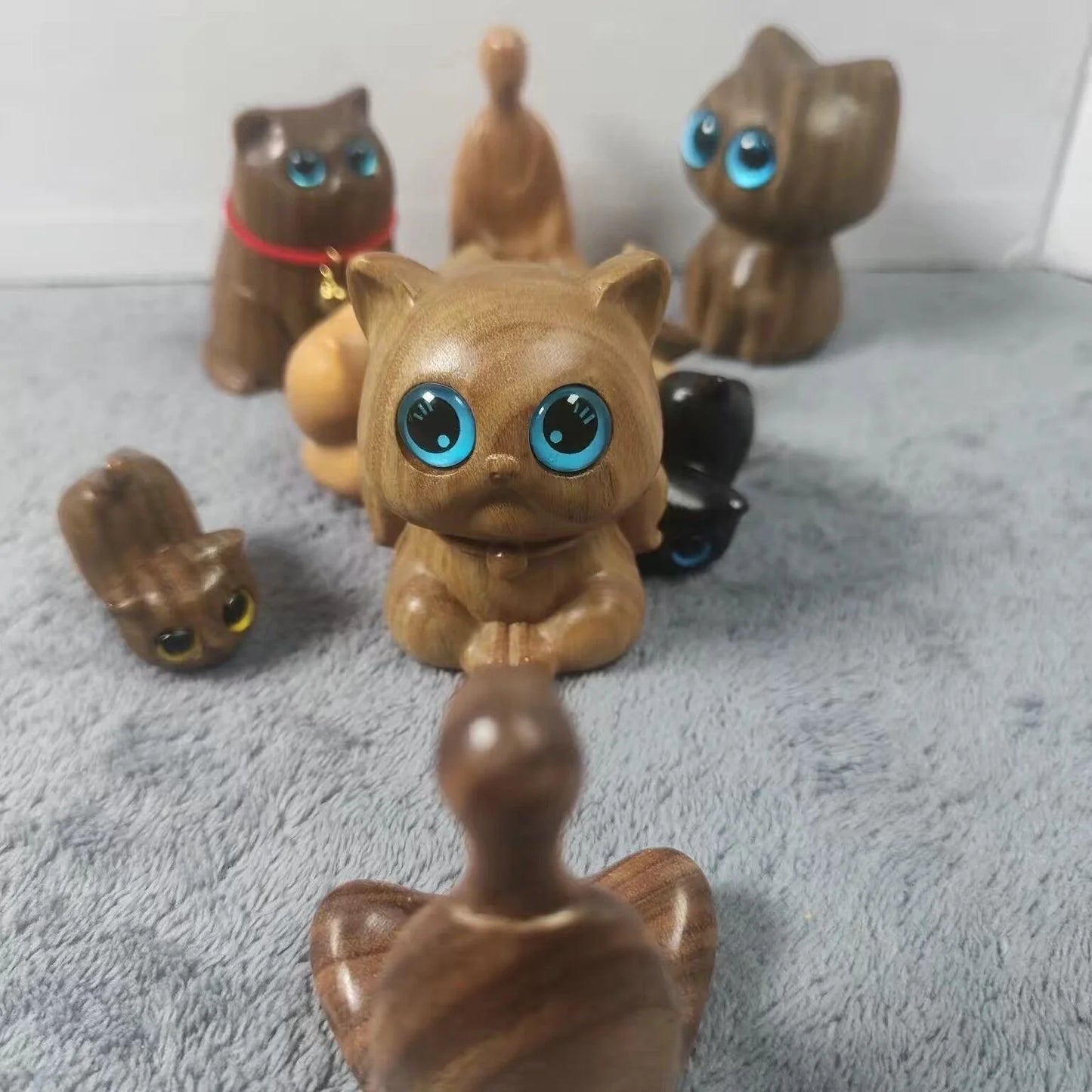 Handcrafted sandalwood kitten ornaments in various styles and colours