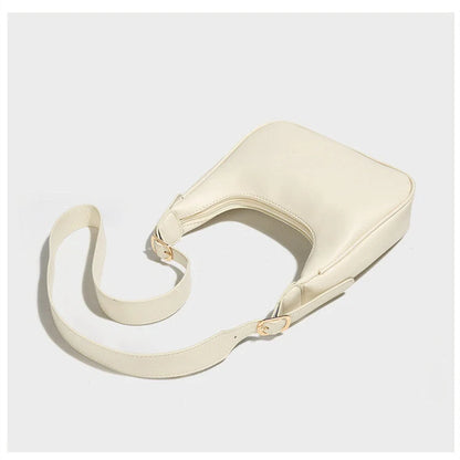 Women's soft PU crescent crossbody bag with internal compartments in white and black
